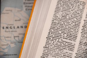 dictionary laid open over map of England